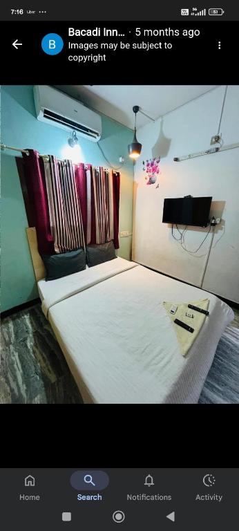 a picture of a bedroom with a large bed at Bacadi inn Service apartment in Edappally