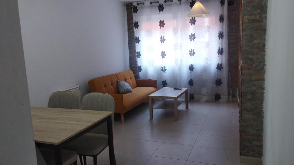 a living room with a couch and a table at Calatorao apartamentos in Calatorao