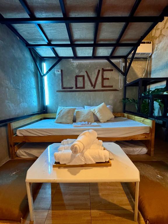 a room with two beds and a table with towels at LoftVibes San Juan - 4 in San Juan