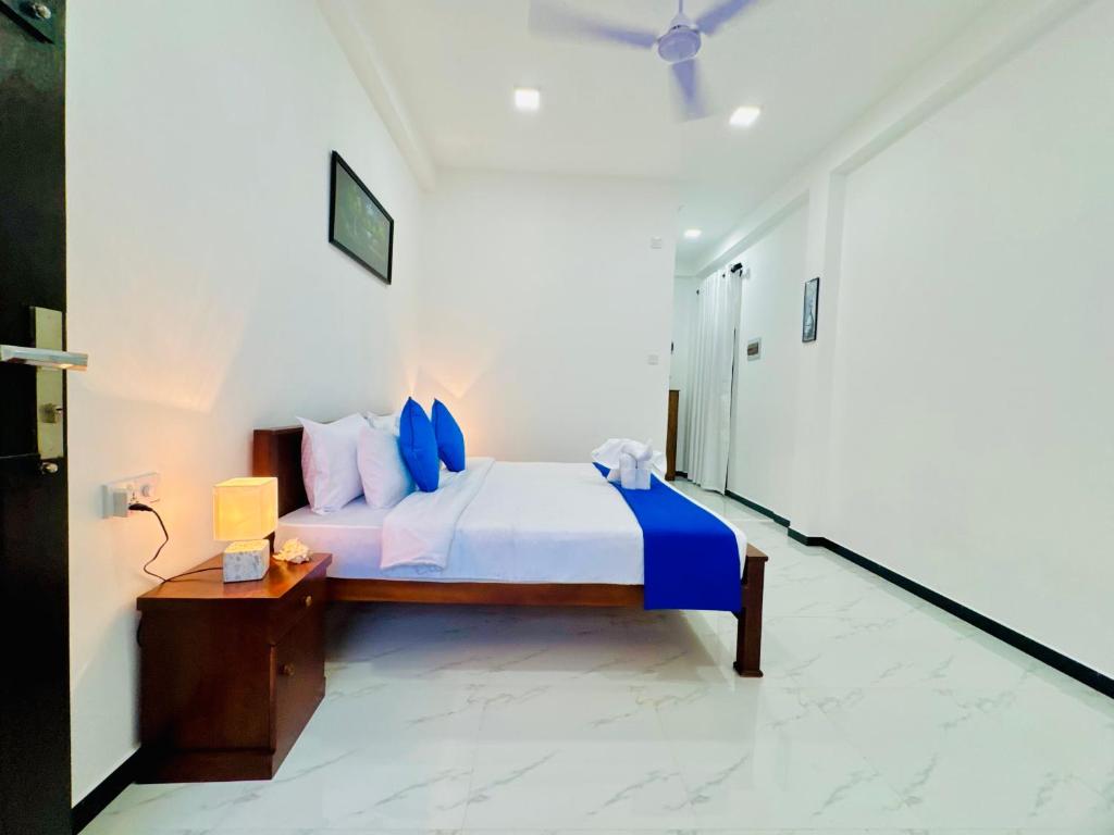 Postel nebo postele na pokoji v ubytování AP Pearl Palace -Tangalle