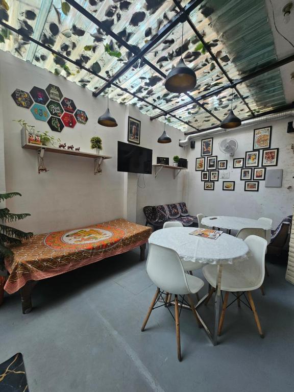 a room with a table and chairs and a couch at The Agra Retreat-walk to the Taj Mahal in Agra