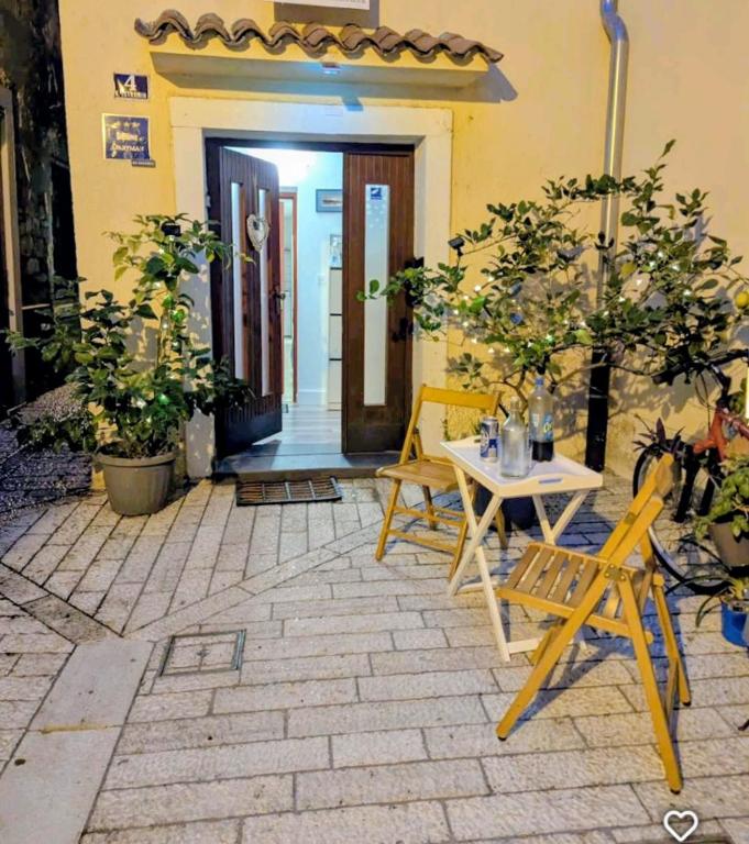 a patio with a table and chairs in front of a door at Old Town Charmer in Poreč