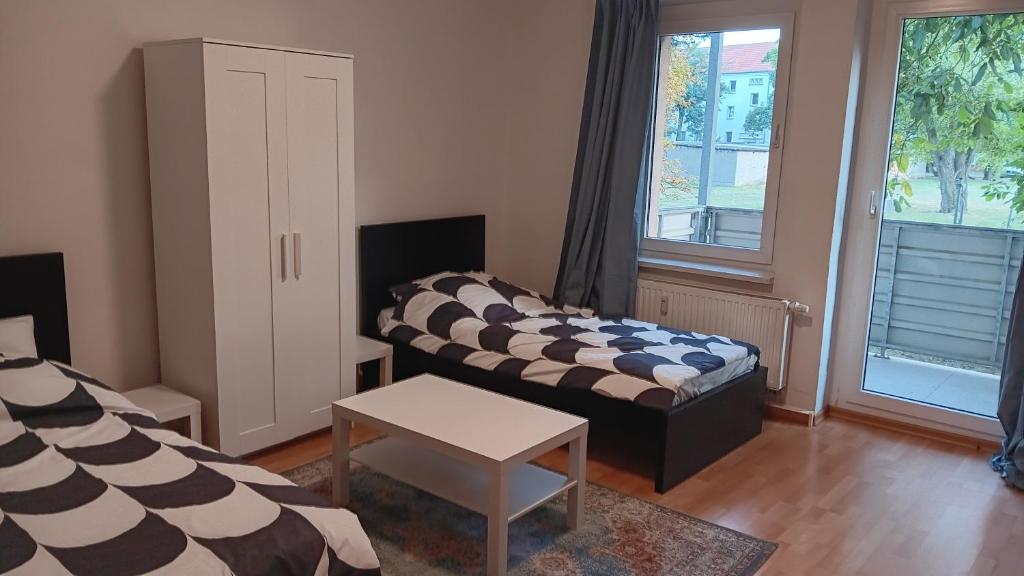 a living room with two beds and a table at Crew Quartier ALL-INCLUSIVE Serviced Apartment in Krostitz in Krostitz