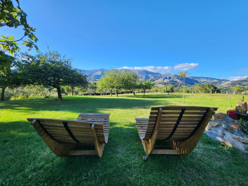 two chairs sitting on the grass in a field at Rincón de Madagascar VV-2192-AS in Arriondas