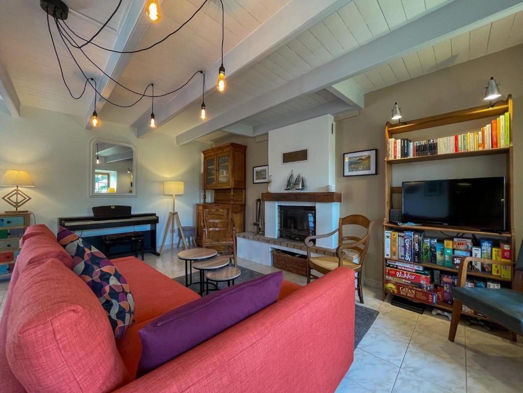 a living room with a couch and a tv at Ty Levenez in Paimpol