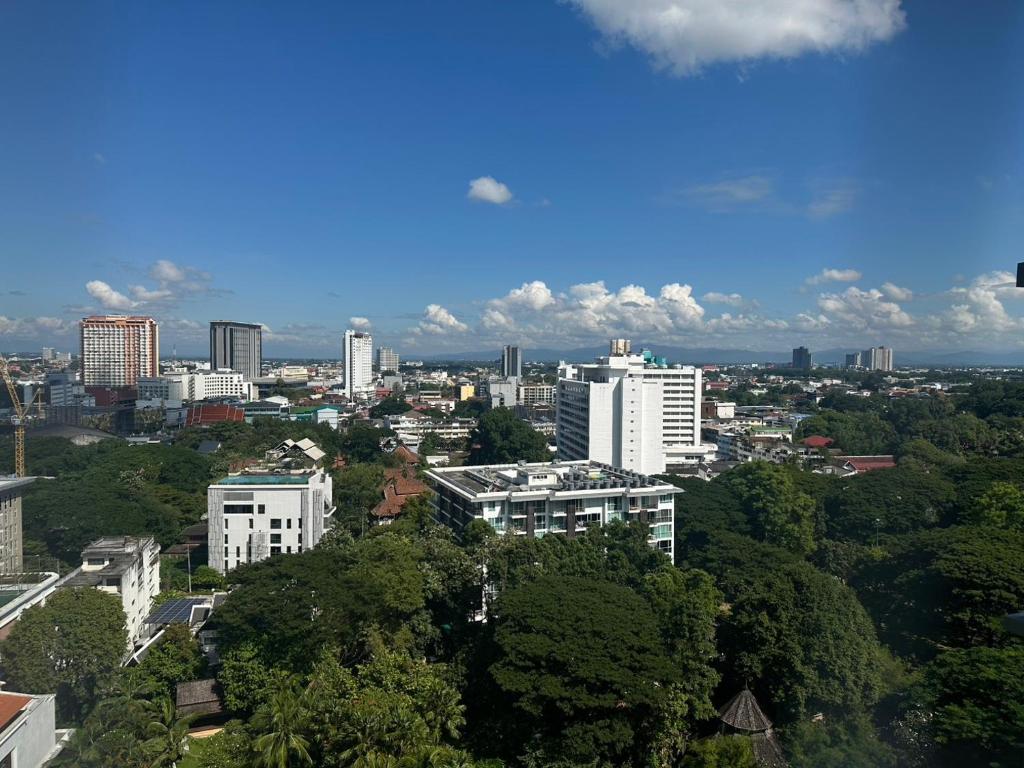 a view of a city with trees and buildings at astra sharingla view top floor in Chiang Mai