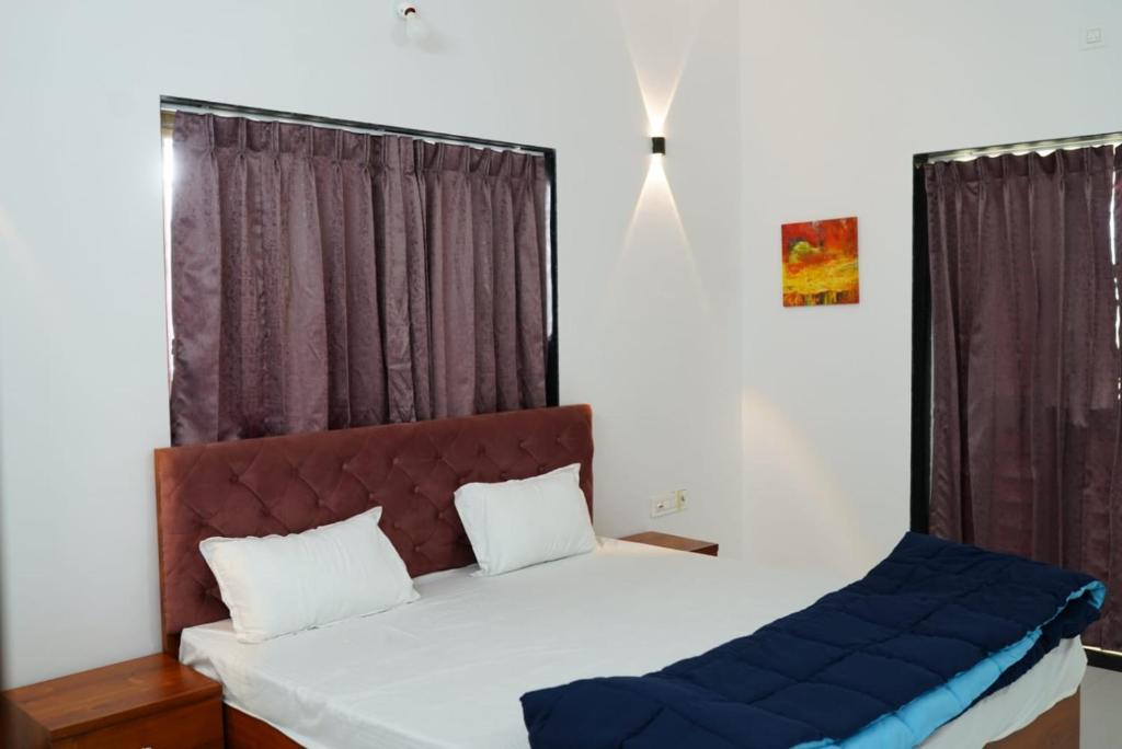 a bedroom with a bed and a window at ll EMPYREAN STAY ll FLAGSHIP INN ll DOUBLE ROOM ll in Lonavala