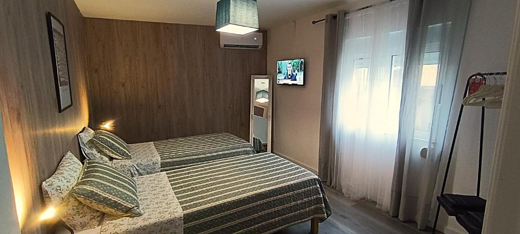 a small bedroom with a bed in a room at Casa 2 Andrades in Belmonte