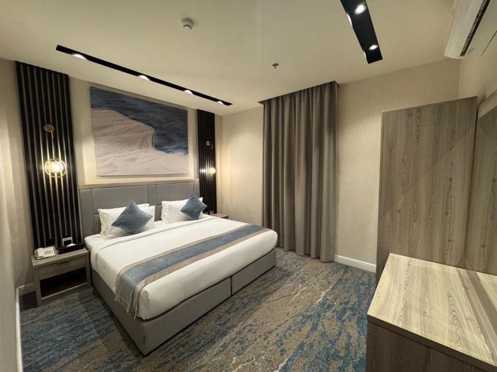 a hotel room with a bed and a bathroom at Niyama Hotel in Umm Lajj