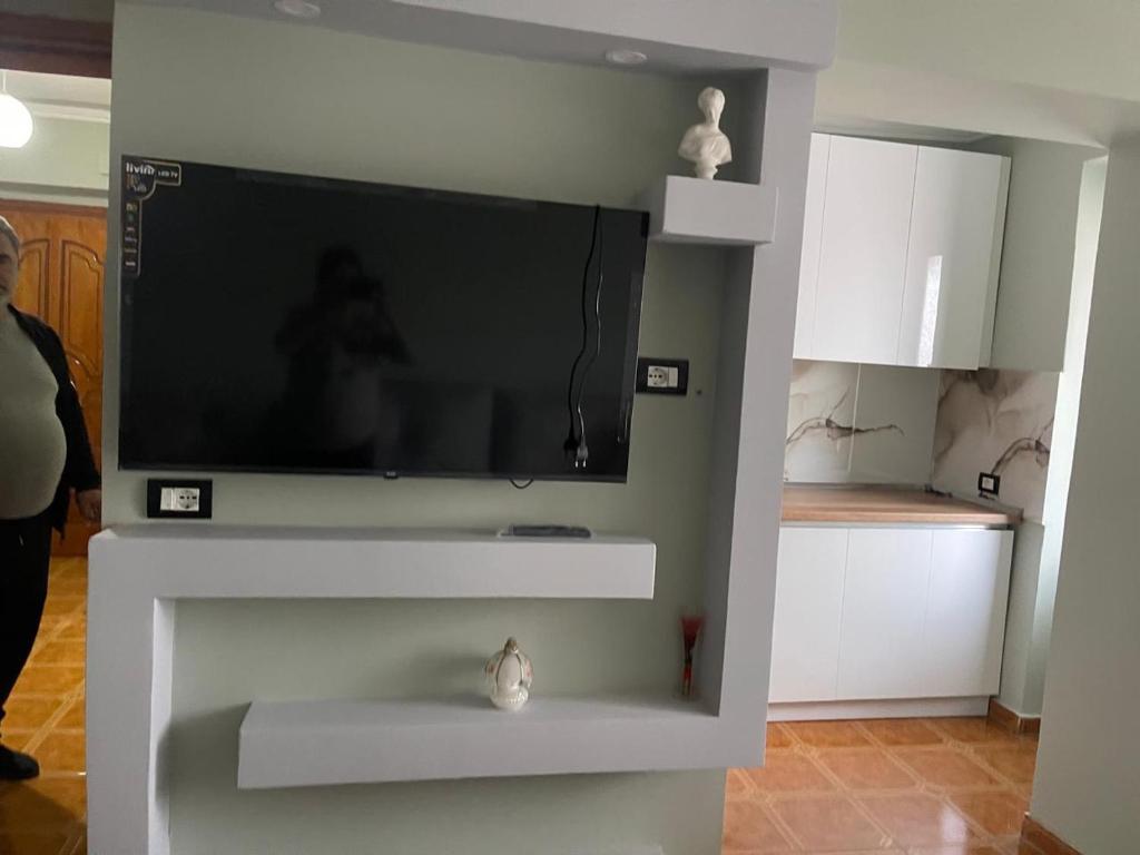 a flat screen tv on a wall in a living room at Amber Comfort Home in Lushnjë