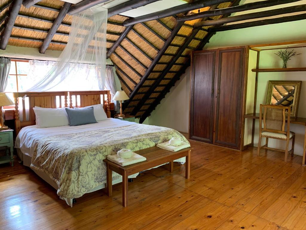 a bedroom with a large bed and a wooden floor at Bramleigh Farm in Nottingham Road