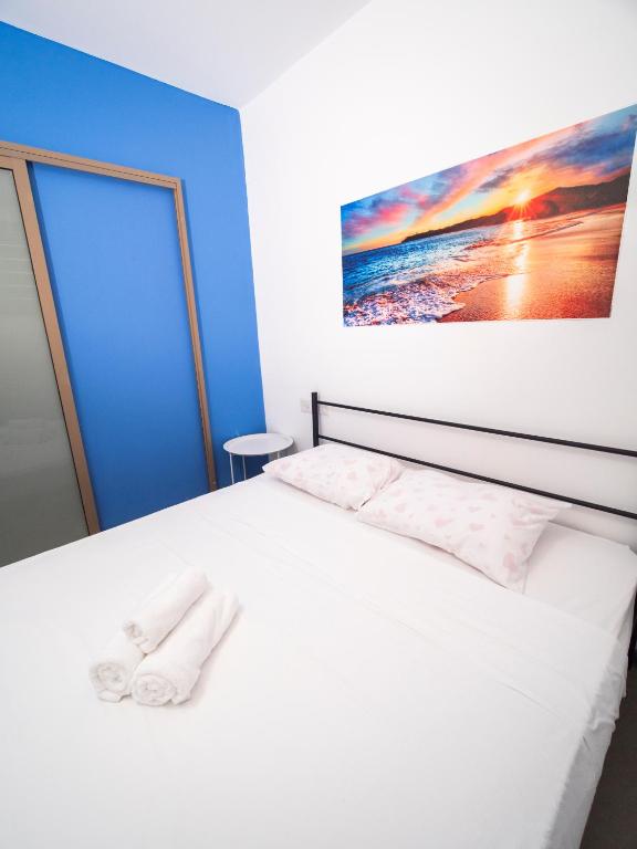 a bedroom with a bed with two towels on it at כפר הצוללים in Eilat