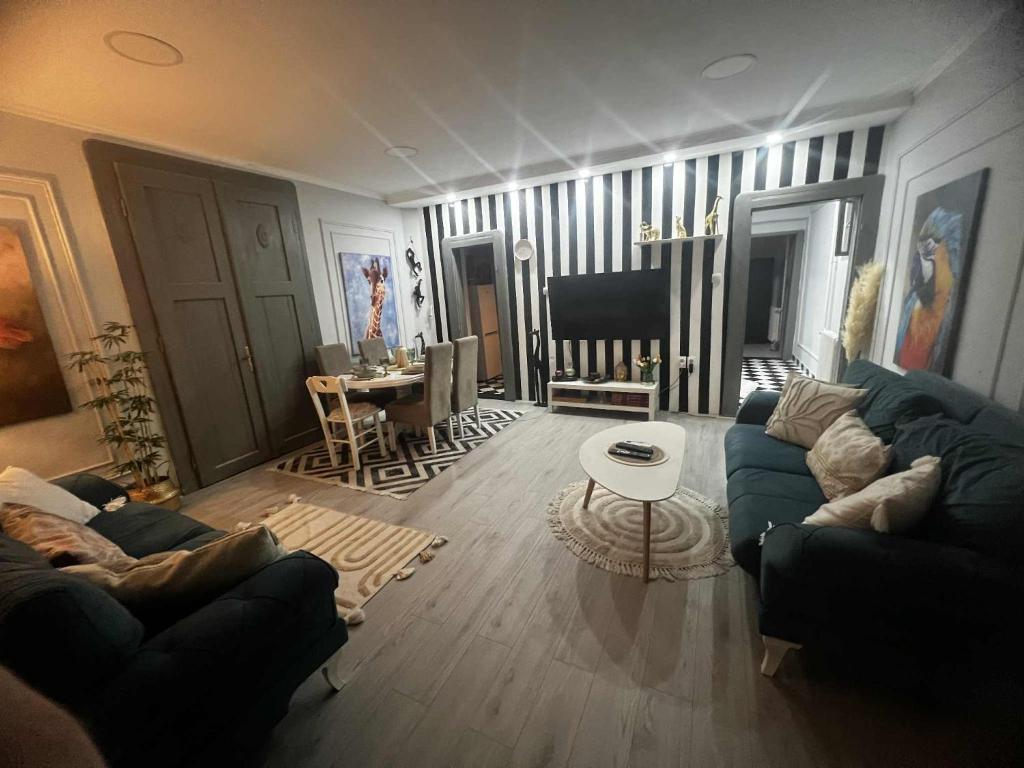 a living room with two couches and a table at JUCIN apartman in Zrenjanin