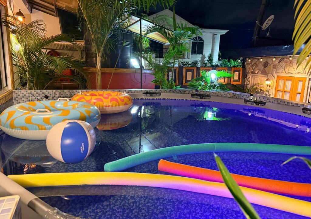 a pool with colorful inflatables in a hotel at Retreat Cameroon BASTOS in Yaoundé