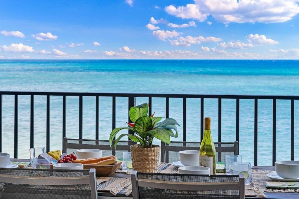 a dining table with a view of the ocean at Hololani A204 in Kahana
