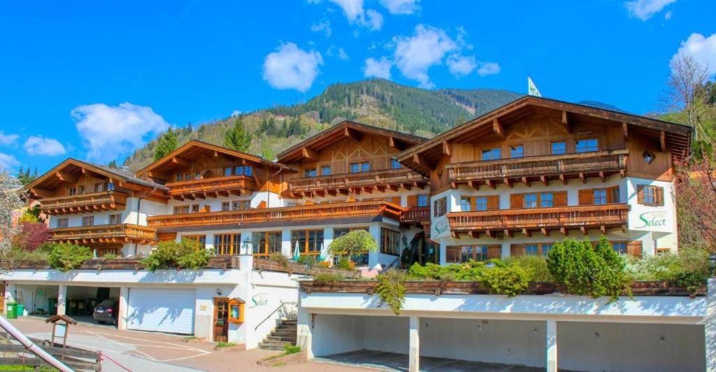 a large building with a mountain in the background at Select Apartment TOP 8 Kaprun Fürth by Jara in Piesendorf