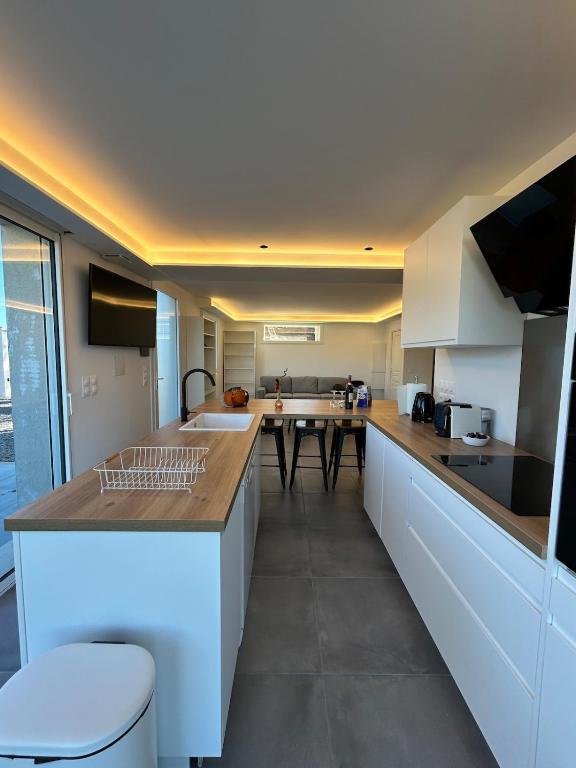 a kitchen with white cabinets and a counter top at 5 bedroom house, office, laundry room in Colomars