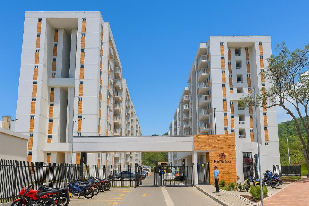 two tall buildings with motorcycles parked in front of them at APARTAMENTO FAMILIAR VILLETA in Villeta