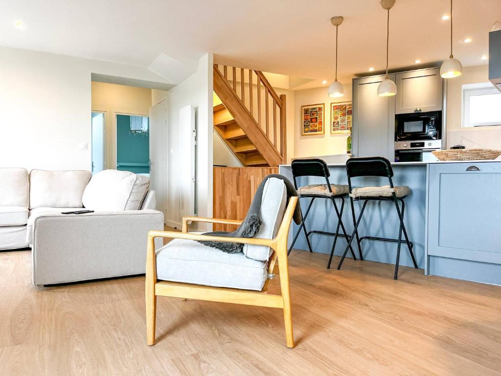 a living room with a couch and a table and chairs at John in Étaples