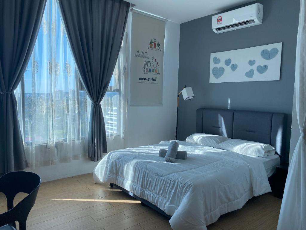 Ένα ή περισσότερα κρεβάτια σε δωμάτιο στο Borneo Hideaway - Manhattan Suites, ITCC