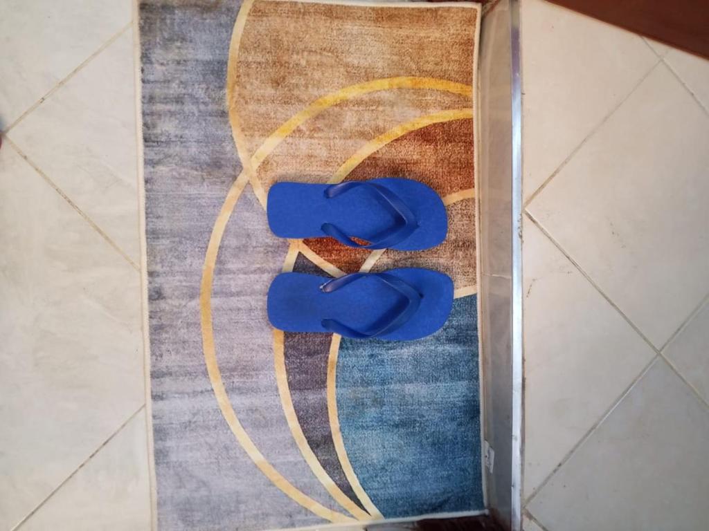 a pair of blue shoes sitting on a rug at Luxe Homes in Meru