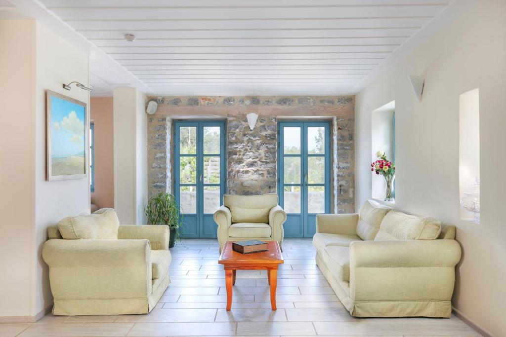 a living room with two couches and a table at Thirides Beach Resort in Gythio