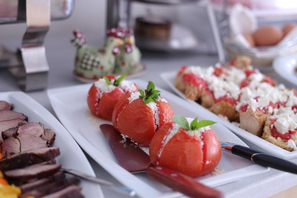 a table with several plates of desserts on plates at Thirides Beach Resort in Gythio