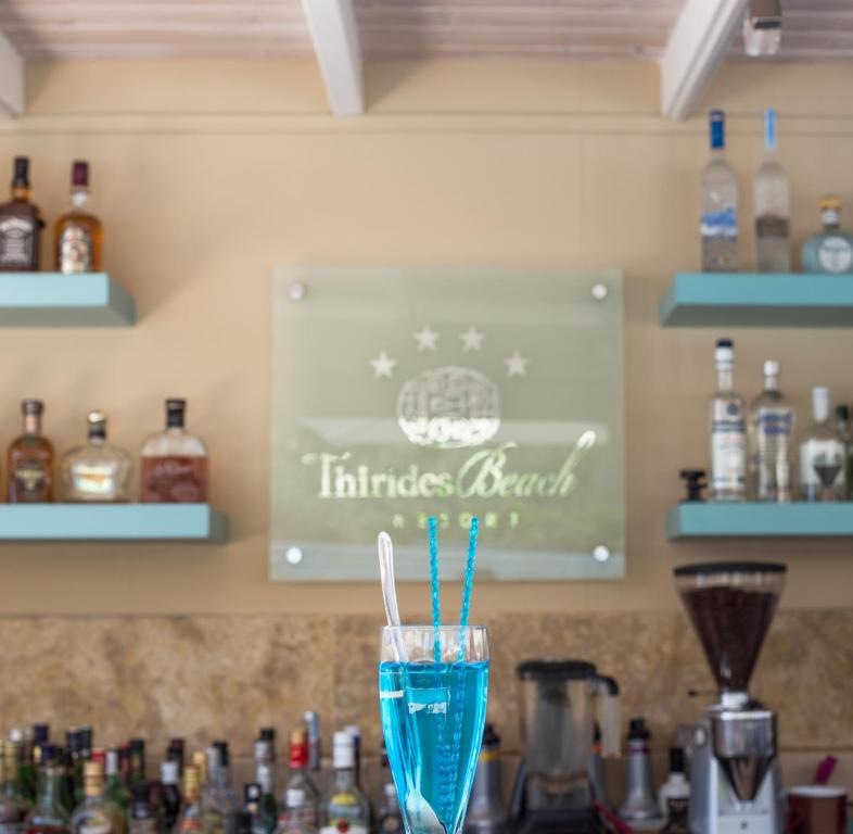 a glass of blue liquid sitting on top of a counter at Thirides Beach Resort in Gythio