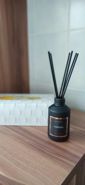 a black container with sticks in it on a table at M-Suites - Near Frankfurt Airport in Hattersheim