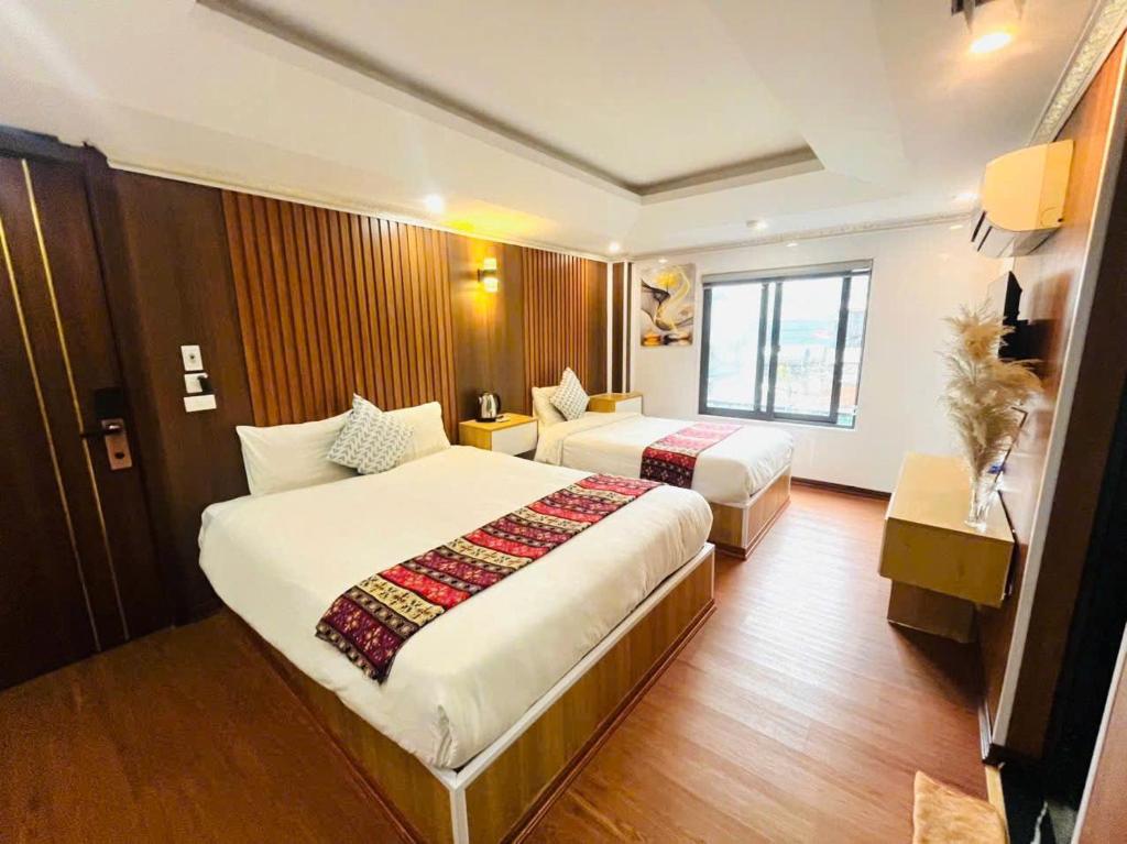 Ένα ή περισσότερα κρεβάτια σε δωμάτιο στο SaPa Camellia Hotel