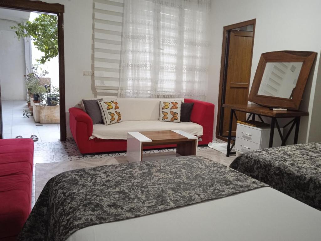 a living room with two beds and a couch at Derin park otel in Sanlıurfa