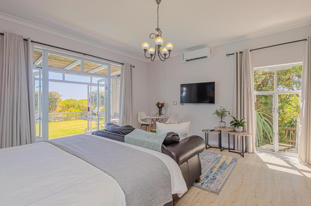 a bedroom with a large bed and a large window at Flensborg Studios & Penthouse - Langebaan Golf Estate in Langebaan