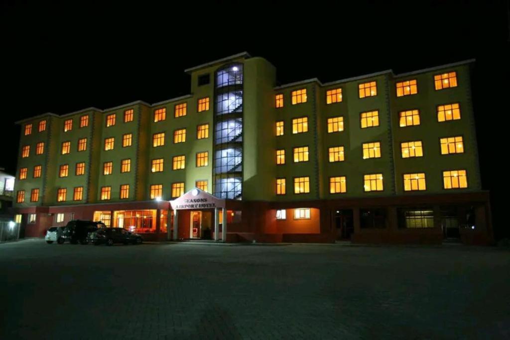 a large building with lit up windows at night at Nairobi Seasons Airport Hotel in Nairobi