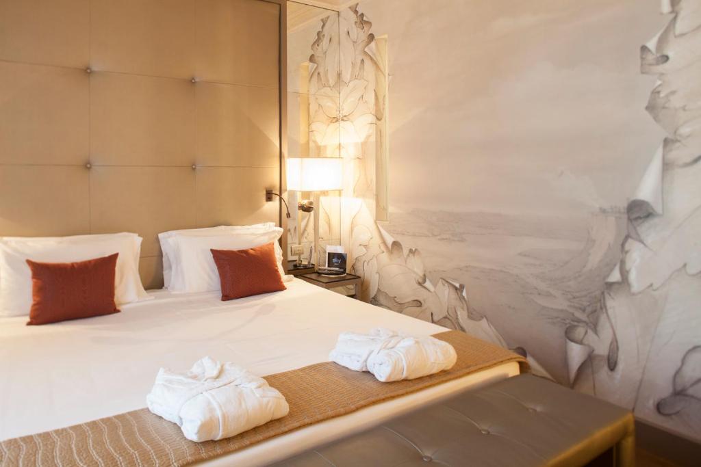 Postel nebo postele na pokoji v ubytování Palazzo Righini