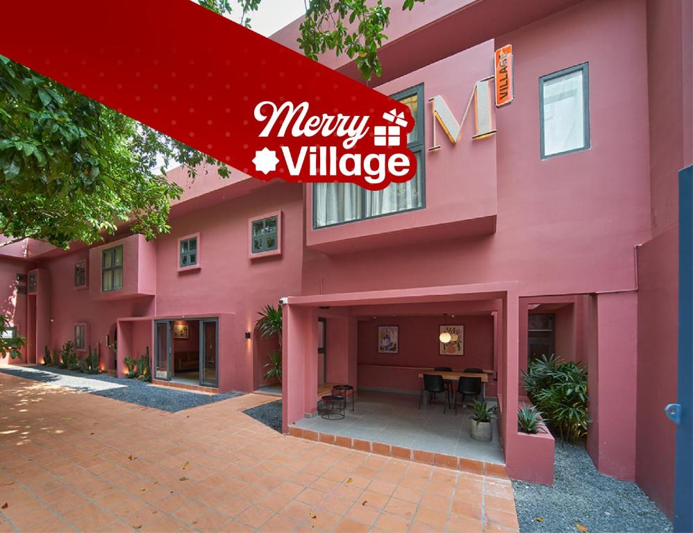 a pink building with a sign that reads merry village at M Village Living Hồ Biểu Chánh in Ho Chi Minh City