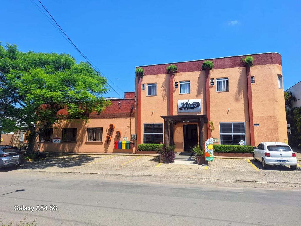 a building on a street with a car parked in front at Hotel Niro in Montenegro