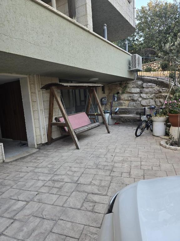 a patio with a pink mattress under a building at Nancy zimr 1 in Massada
