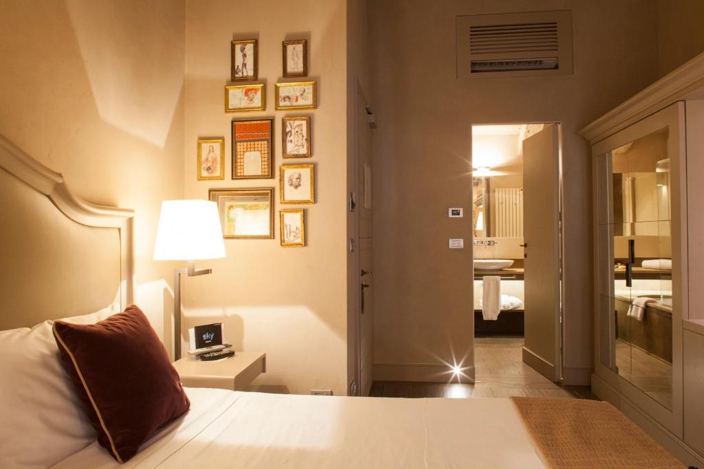Postel nebo postele na pokoji v ubytování Palazzo Righini