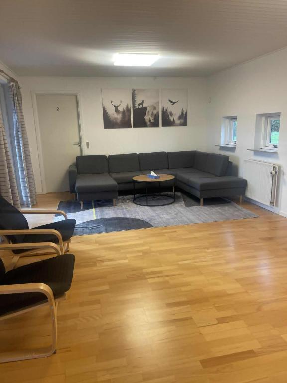 a living room with a couch and a table at Joy house in Munkebo