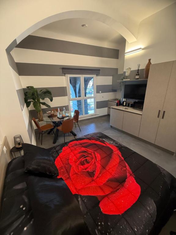 a living room with a red rose on the floor at Suite degli Archi - Lusso e charme fronte Acquario in Genova