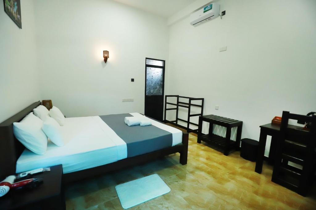 Ένα ή περισσότερα κρεβάτια σε δωμάτιο στο Lisa Homestay Yala
