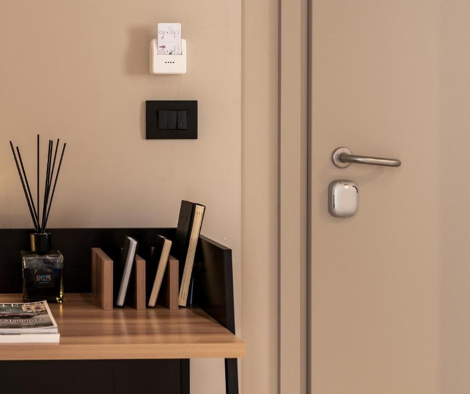 a room with a desk with a door and a table at Amare Suite & Apartments in Bellaria-Igea Marina