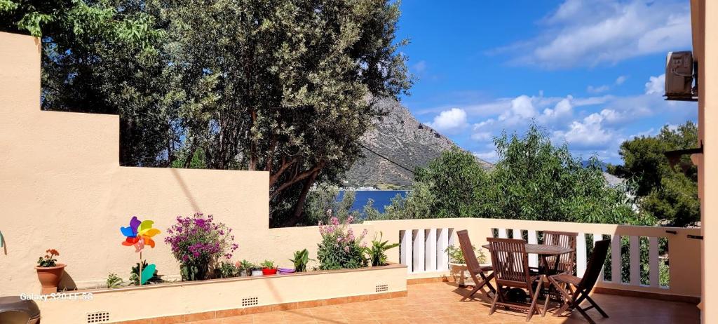 a patio with a table and chairs and a fence at Myrties Boutique Apartments in Myrties