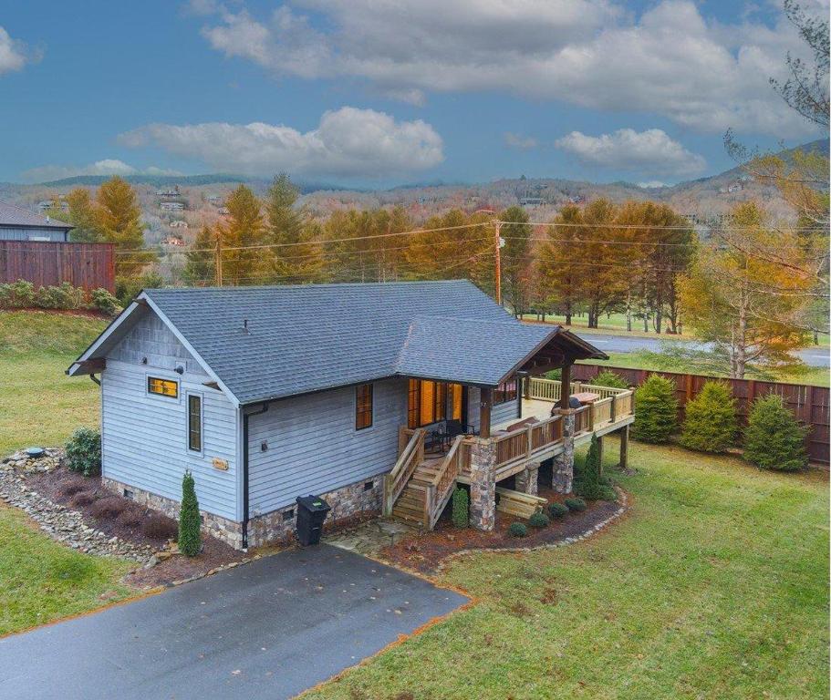 a small house with a porch and a deck at Banner Sky in Banner Elk