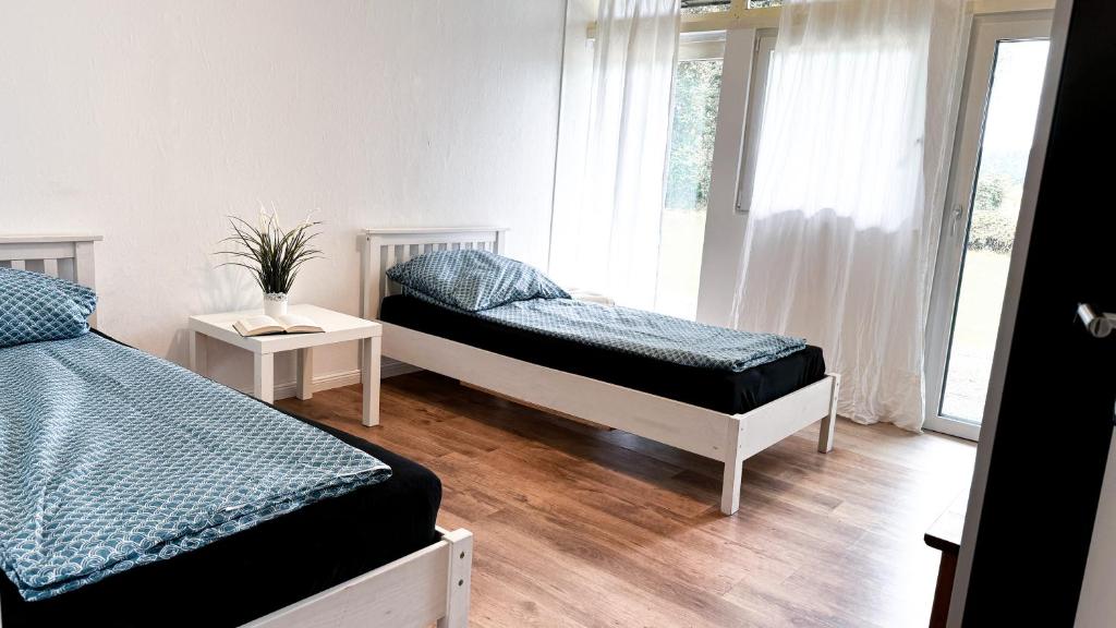 a bedroom with two beds and a window at Haus für 8 Personen, 4 Zimmer in Wenzendorf