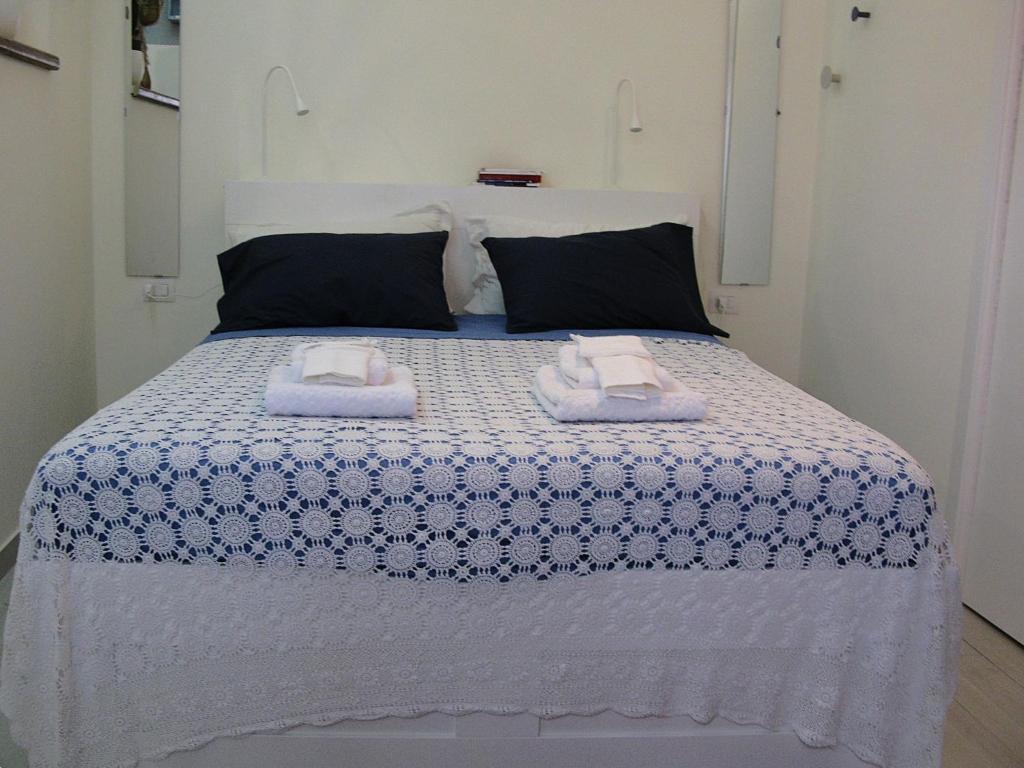 a bedroom with a bed with two towels on it at Charming Holiday Home in the historic center of Pietrelcina in Pietrelcina
