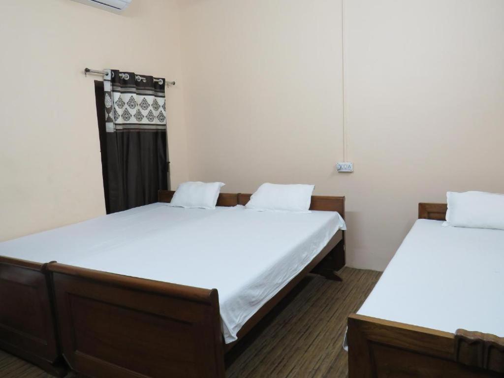 Ένα ή περισσότερα κρεβάτια σε δωμάτιο στο BM Shaw Guest House