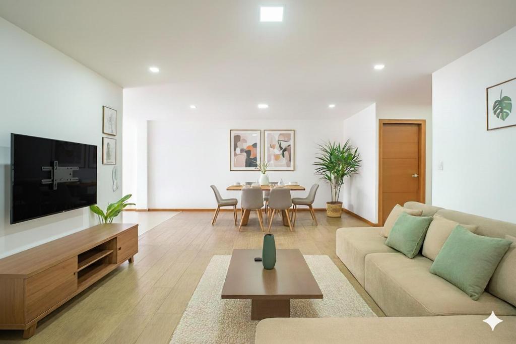 a living room with a couch and a table at The Andes apartment Patio & Luxury in Cuenca