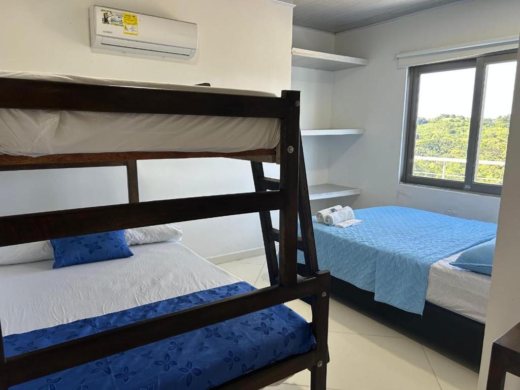 a bedroom with two bunk beds and a window at Hotel mirador Dubai in San Antero