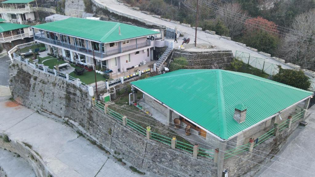 a building with a green roof on top of it at 2Bhk Home By Da Alohas Mukhteshwar in Mukteswar